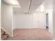 Large unfinished basement with clean carpet and access to additional room at 8721 E Cornell Dr, Denver, CO 80231
