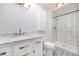 Modern bathroom with a marble countertop vanity and shower with white marble tiling at 8721 E Cornell Dr, Denver, CO 80231