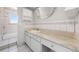 Bright bathroom features a vanity with marble countertop and white cabinets at 8721 E Cornell Dr, Denver, CO 80231
