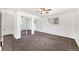 Spacious bedroom featuring carpet, a ceiling fan and large closet with mirrored doors at 8721 E Cornell Dr, Denver, CO 80231