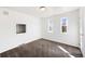 An empty bedroom featuring neutral carpet and windows at 8721 E Cornell Dr, Denver, CO 80231