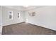 Bright bedroom with two large windows and neutral-colored carpet flooring at 8721 E Cornell Dr, Denver, CO 80231