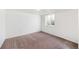 Simple bedroom with neutral carpeting and window providing natural light at 8721 E Cornell Dr, Denver, CO 80231