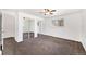 A bedroom with mirror door closet, neutral carpet, and window at 8721 E Cornell Dr, Denver, CO 80231