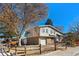 Charming split-level home boasts lovely curb appeal with mature trees and partial brick facade at 8721 E Cornell Dr, Denver, CO 80231