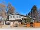 Charming home with light siding, wooden fence and shutters creates welcoming outdoor ambiance at 8721 E Cornell Dr, Denver, CO 80231