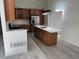 A spacious kitchen featuring wood cabinets, stainless steel appliances, and a large island with a sink at 8721 E Cornell Dr, Denver, CO 80231