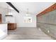 Living room with wood floors and ample natural light from large picture window at 8721 E Cornell Dr, Denver, CO 80231