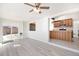 Open-concept living room with exposed brick and view into the kitchen, perfect for entertaining at 8721 E Cornell Dr, Denver, CO 80231