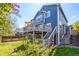 The backyard is an outdoor escape with a spacious deck, stairs, and luscious lawn at 5977 S Rock Creek Dr, Castle Rock, CO 80109