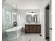 Bright primary bathroom features a glass shower, soaking tub and double sink vanity with modern finishes at 5977 S Rock Creek Dr, Castle Rock, CO 80109
