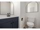 Powder room featuring a dark vanity with black hardware and fixtures at 5977 S Rock Creek Dr, Castle Rock, CO 80109
