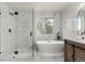 This bright bathroom features a walk-in shower, soaking tub, double sink vanity, and stylish fixtures at 5977 S Rock Creek Dr, Castle Rock, CO 80109