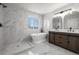 Bright bathroom with tiled walls, modern fixtures, soaker tub, and walk-in shower at 5977 S Rock Creek Dr, Castle Rock, CO 80109