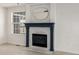 Close up of the fireplace with dark blue accents, white marble details, and a unique rounded mirror at 5977 S Rock Creek Dr, Castle Rock, CO 80109