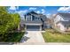 Charming two-story home with a well-manicured lawn, stone accents, and inviting curb appeal at 5977 S Rock Creek Dr, Castle Rock, CO 80109
