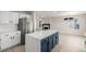 Bright kitchen with stainless steel appliances and a center island with a view into the living area at 5977 S Rock Creek Dr, Castle Rock, CO 80109