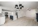 Open-concept kitchen features stainless steel appliances, white cabinetry, and island with dark blue accents at 5977 S Rock Creek Dr, Castle Rock, CO 80109