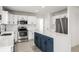 Bright kitchen with white countertops, stainless appliances, and a navy blue kitchen island at 5977 S Rock Creek Dr, Castle Rock, CO 80109