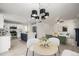 Open-concept living space with a kitchen island, modern lighting, and an inviting living area at 5977 S Rock Creek Dr, Castle Rock, CO 80109