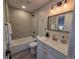 Nicely remodeled bathroom featuring tub/shower combo with gray tile surround and modern vanity at 1250 S Monaco Pkwy # 17, Denver, CO 80224
