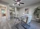 Home office featuring built-in shelving, modern desk, gray flooring, ceiling fan and natural light at 1250 S Monaco Pkwy # 17, Denver, CO 80224
