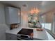 Open-concept kitchen showcasing stainless steel appliances and gray cabinets at 1250 S Monaco Pkwy # 17, Denver, CO 80224