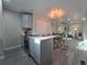 Stylish open-plan kitchen with stainless steel appliances and gray cabinets at 1250 S Monaco Pkwy # 17, Denver, CO 80224