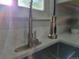 Close-up of a modern kitchen faucet with pull-down sprayer and quartz countertops at 1250 S Monaco Pkwy # 17, Denver, CO 80224