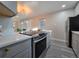 Modern kitchen with stainless appliances and gray cabinets at 1250 S Monaco Pkwy # 17, Denver, CO 80224