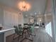 Open-concept living and dining area with modern lighting and updated flooring at 1250 S Monaco Pkwy # 17, Denver, CO 80224