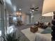 Open-concept living room with modern ceiling fan and plenty of natural light at 1250 S Monaco Pkwy # 17, Denver, CO 80224