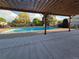 A refreshing community pool features clear blue water and a pergola covered patio at 1250 S Monaco Pkwy # 17, Denver, CO 80224