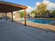 Community pool surrounded by a patio and pergola, perfect for relaxing and enjoying the outdoors at 1250 S Monaco Pkwy # 17, Denver, CO 80224