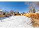 Spacious backyard with a wooden fence and a grassy area at 2918 Ames St, Wheat Ridge, CO 80214