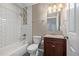 Updated bathroom with subway tile shower and vanity with cabinet at 2918 Ames St, Wheat Ridge, CO 80214