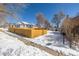 View of home from street showing the yard with a wooden fence offering privacy at 2918 Ames St, Wheat Ridge, CO 80214