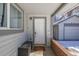 A welcoming front door with sidelight, brick accents, and convenient outdoor storage at 2918 Ames St, Wheat Ridge, CO 80214