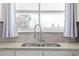 Well-lit kitchen sink featuring a modern faucet and granite countertops at 2918 Ames St, Wheat Ridge, CO 80214