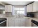 Well-lit kitchen with granite countertops, stainless steel appliances, and ample cabinet space at 2918 Ames St, Wheat Ridge, CO 80214