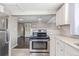 Kitchen with stainless steel appliances and view into dining area at 2918 Ames St, Wheat Ridge, CO 80214