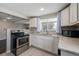 Bright kitchen with granite countertops, stainless steel appliances, and ample cabinet space at 2918 Ames St, Wheat Ridge, CO 80214