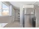 Kitchen with stainless steel refrigerator, and access to back entrance at 2918 Ames St, Wheat Ridge, CO 80214