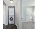 Hallway featuring stacked washer and dryer near bedroom entrance at 2918 Ames St, Wheat Ridge, CO 80214