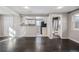 Bright living room with hardwood floors, access to kitchen and bathroom, and recessed lighting at 2918 Ames St, Wheat Ridge, CO 80214