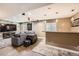 Finished basement features living area with TV, a wet bar with pendant lights, and ample entertainment space at 10774 Chadsworth Ln, Highlands Ranch, CO 80126