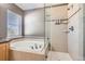 Bright bathroom featuring a soaking tub and glass enclosed shower at 10774 Chadsworth Ln, Highlands Ranch, CO 80126