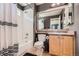 Modern bathroom features a tub and shower, tile surround, and stylish vanity with mirror at 10774 Chadsworth Ln, Highlands Ranch, CO 80126