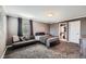 Inviting bedroom featuring a futon, soft carpet, and a view to the bathroom at 10774 Chadsworth Ln, Highlands Ranch, CO 80126