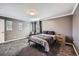 Spacious bedroom with a comfortable bed, neutral decor and soft carpeting at 10774 Chadsworth Ln, Highlands Ranch, CO 80126